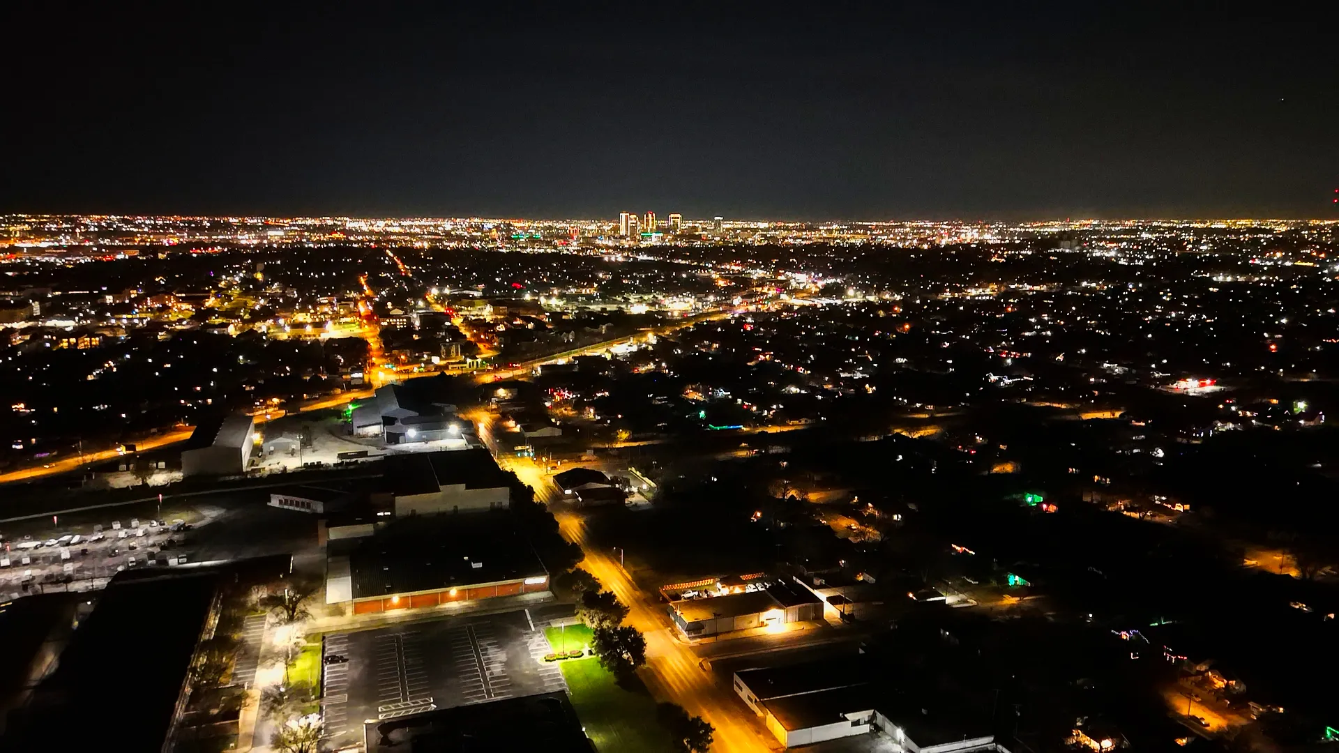 Stunning night view of the Fort Worth skyline, with city lights reflecting off the Trinity River and towering skyscrapers.